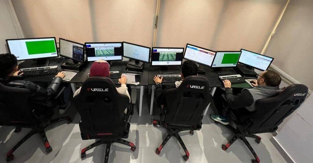 Collectors processing live matches with dual monitors in Cairo collection center